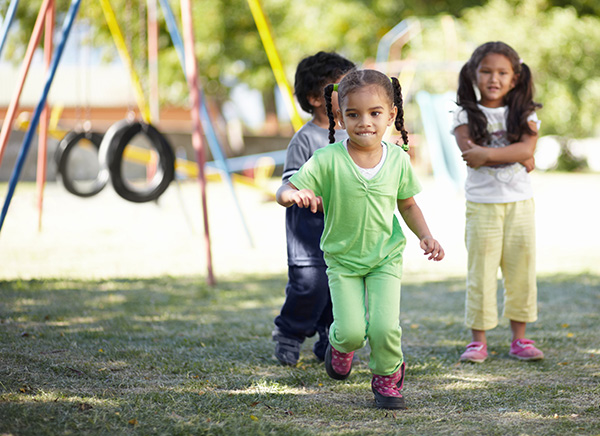 Children playing outdoors on playground equipment
